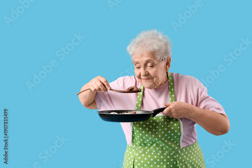 Senior woman in apron tasti...