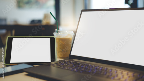 close up shot, work outside the office in cafe with laptop computer, tablet, mobile phone and ice coffee on table