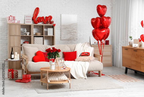 Interior of light living room decorated for Valentine's Day with sofa and balloons