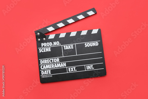 Movie clapper on red backgr...