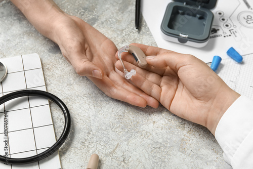 Female otolaryngologist giv...