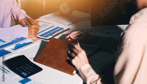 Above table with finance papers, graphs and big data during teamwork meeting with accounting or marketing team discussing budget, strategy or growth development. Closeup of SEO team doing research