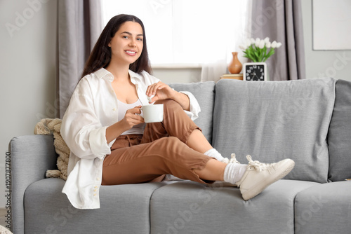 Pretty young woman with cup...