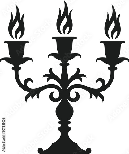 Black silhouette of a three-armed candelabra with lit candles flame light