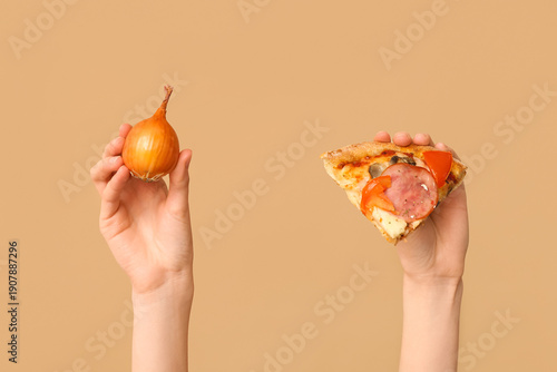 Female hands holding pizza ...