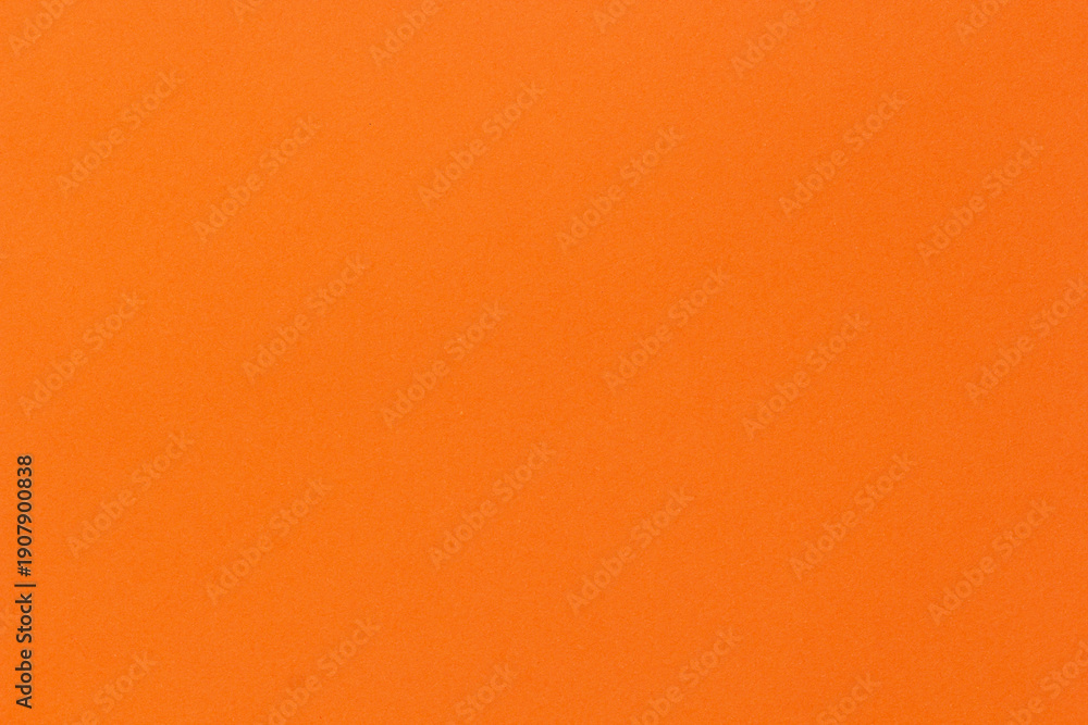 Fototapeta premium Orange solid color texture background with subtle grain surface