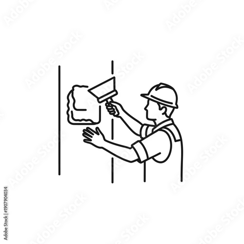 Drywall finisher applying plaster to a wall surface with a putty knife