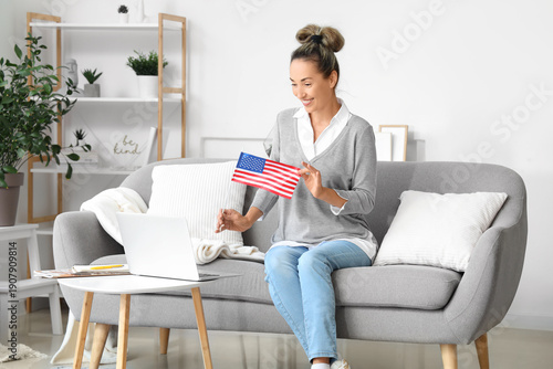 Mature woman with laptop studying English online at home