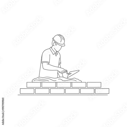 Bricklayer spreading cement mortar on brickwork with a metal trowel