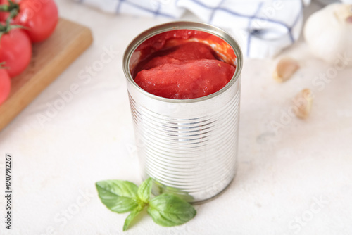 Tin can with tomatoes on li...