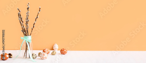Photography Glass vase with pussy willow branches, turquoise ribbon and Easter eggs on white