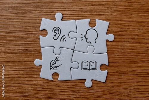 Photography Jigsaw puzzle pieces with icons representing listening, speaking, writing, and reading