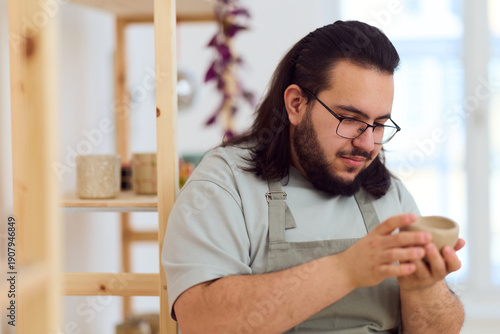 Canvas Print Focused Potter In Apron Creating Handmade Pottery In A Bright Studio Workshop Sc