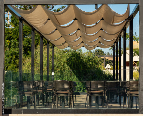 Shaded outdoor dining area with retractable fabric awning
