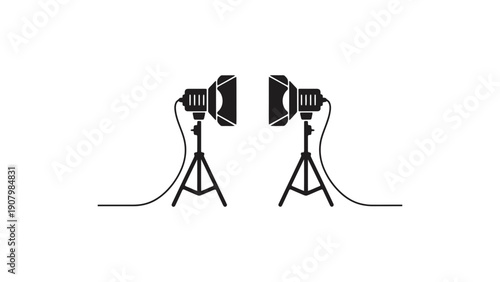 Two studio lights on tripods are set up for a photoshoot.