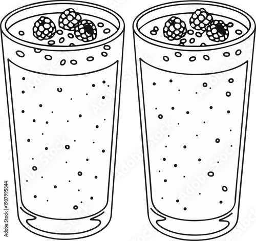 Two tall glasses filled with a bubbly liquid and topped with berries