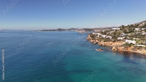 Wallpaper Mural Drone footage of a Mediterranean coastline featuring calm blue waters, shoreline, and seaside village. Torontodigital.ca