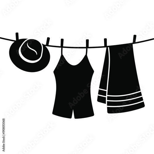 Black silhouette of summer clothes and hat on a clothesline