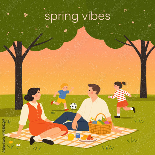 Family picnic on green lawn in park for spring outing. Father and woman with kids playing outdoors. Leisure time concept.