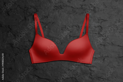 Quadro su tela Blank red wireless bra mockup on black background, top view