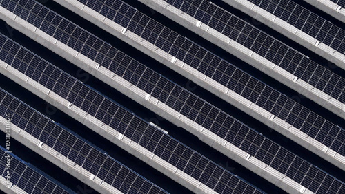 Rows of photovoltaic panels generating clean electricity on a utility scale solar farm, an essential part of the global effort towards sustainability and green energy