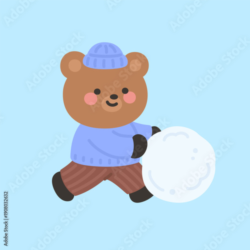 A cute bear pushing a large snowball across the ground