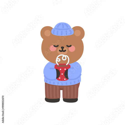 A cute bear enjoying a warm drink