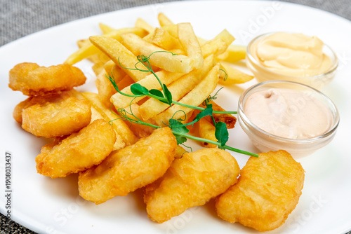 Crispy Chicken Nuggets and French Fries with Sauces, Modern Style. Close-up