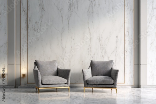 Two contemporary upholstered armchairs sit before an expansive white marble wall accented with gold trim