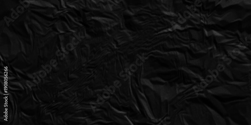 Dark black crumpled paper texture background. black crumpled and top view textures can be used for background of text or any contents.
