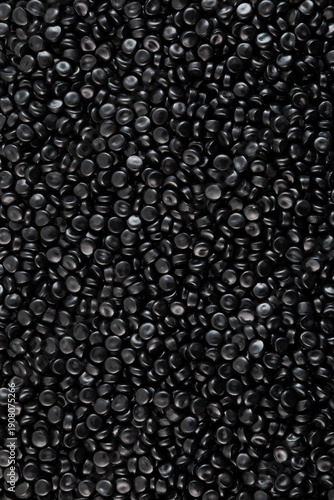 Texture of Black PE pellets, close-up. Black coloured polyethylene granules. Masterbatch, Virgin polymer. Granulated plastic compound