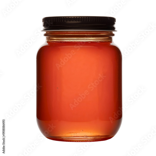 Glass Jar Filled With Amber Liquid Stands on a Simple Background in a Kitchen...