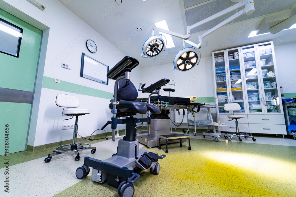 Fototapeta premium High tech surgical room with medical equipment and cabinets. Interior of modern operating theater with overhead LED lamps, surgical table, and storage furniture.