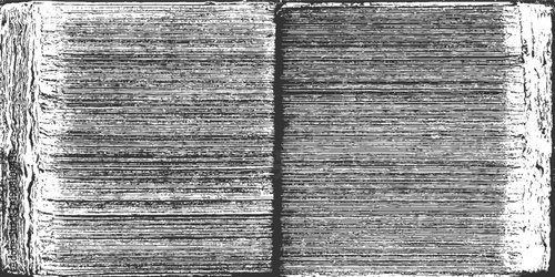 Close up of an open book with textured pages and rough edges in black and white