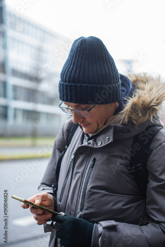 Close up.Portrait of a male tourist using a smartphone to find his way.