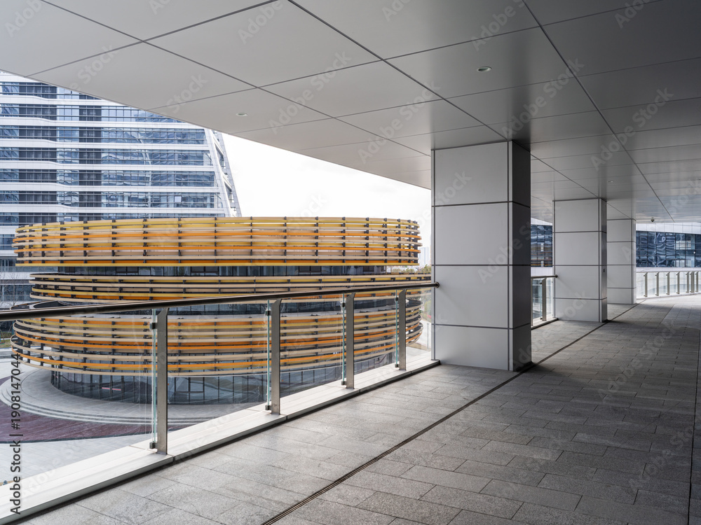 Fototapeta premium Modern architectural walkway view of a circular yellow structural element