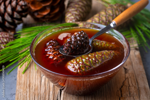 Young pine cones jam in gla...