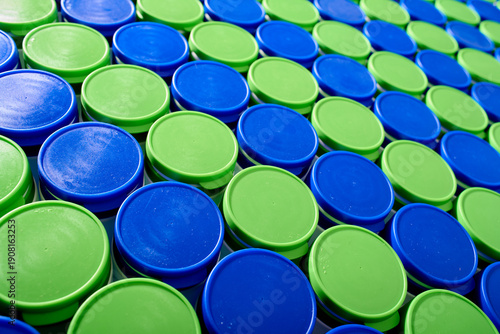 Large group of plastic bottles lined up on a table.