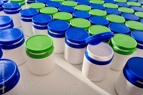 Large group of plastic bottles lined up on a table.