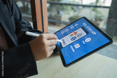 Businesswoman hand using stylus pen on tablet screen touching contact button on real estate property search mobile application interface, House hunting, Online listing, Real estate agent