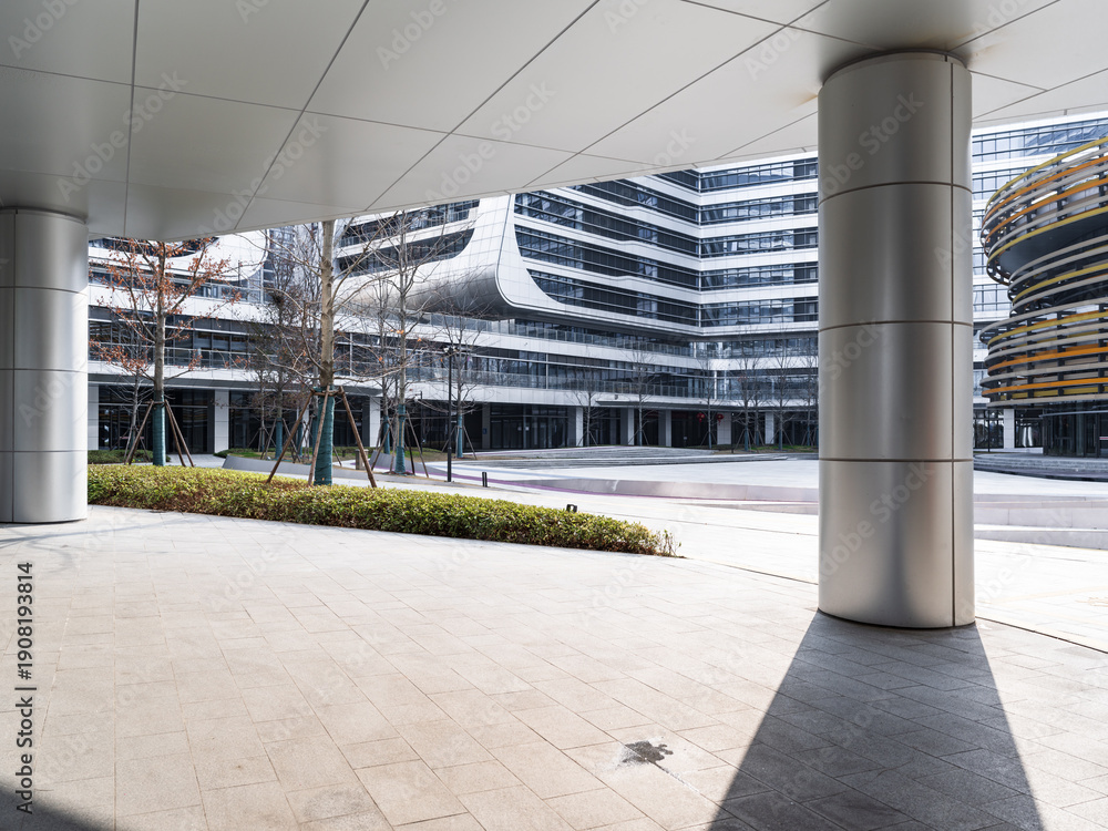 Fototapeta premium Modern architectural complex with open plaza and metallic columns