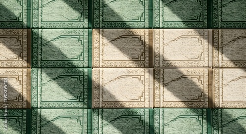 Patterned tiles with green and beige design, sunlight casting shadows on the floor from above