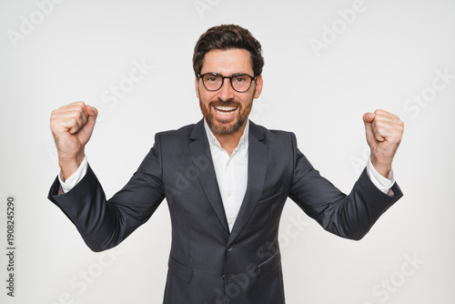 Konstfotografi Excited businessman, portrait and celebration in studio for achievement, success in career