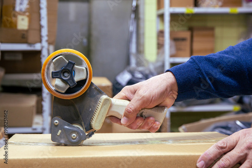 Sealing Cardboard Box with Adhesive Packaging Tape