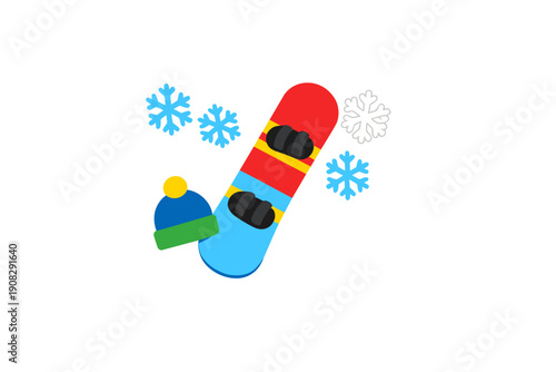 A colorful snowboard with black bindings is shown alongside a blue and green winter beanie with a yellow pom-pom and several snowflakes against a solid black background.