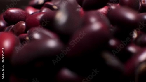 A close-up of a large amount of red kidney beans in a clear storage jar. Macro shot of the beans with a shallow depth of field.