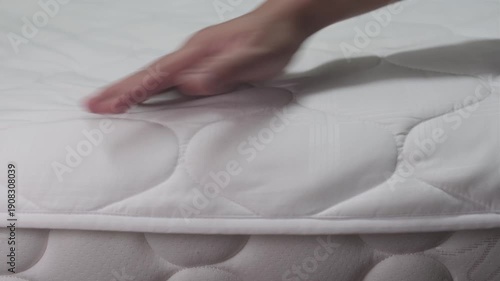 Wallpaper Mural Hand firmly slapping and sweeping a fabric bed sheet to remove dust creating a loud thumping and rustling sound Torontodigital.ca