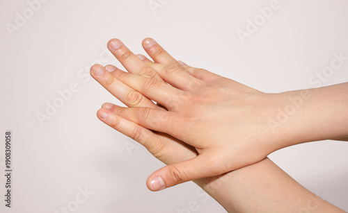 Female hand with a finger touching her finger for disinfekting hands with disinfection liquid or water and soap in hospital. 