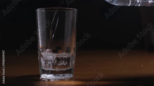 Wallpaper Mural Hand pouring drinking water from a bottle into a glass creating a clear liquid splashing and bubbling sound Torontodigital.ca