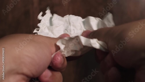 Wallpaper Mural Hands slowly unfolding a crumpled paper creating a soft crinkling and crackling sound Torontodigital.ca